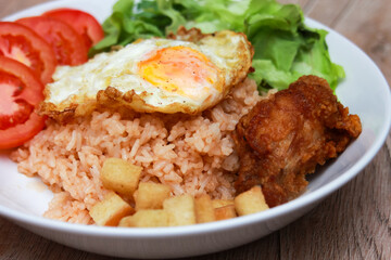 Fried rice with tomato sauce Or as we call it American fried rice Served with fried eggs, fried chicken, fresh stir-fry, and fried bread.