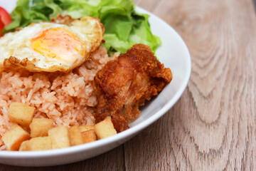 Fried rice with tomato sauce Or as we call it American fried rice Served with fried eggs, fried chicken, fresh stir-fry, and fried bread.