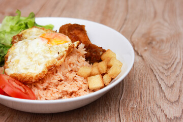 Fried rice with tomato sauce Or as we call it American fried rice Served with fried eggs, fried chicken, fresh stir-fry, and fried bread.