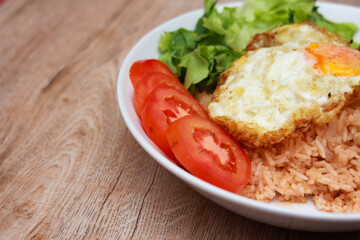 Fried rice with tomato sauce Or as we call it American fried rice Served with fried eggs, fried chicken, fresh stir-fry, and fried bread.