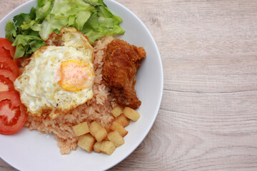 Fried rice with tomato sauce Or as we call it American fried rice Served with fried eggs, fried chicken, fresh stir-fry, and fried bread.