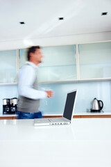 Kitchen, motion blur and man with laptop, morning rush and speed with professional, creative agency...