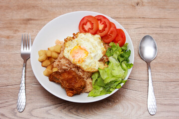 Fried rice with tomato sauce Or as we call it American fried rice Served with fried eggs, fried chicken, fresh stir-fry, and fried bread.