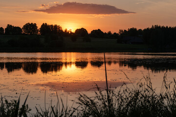 Naklejka premium colorful sunrise, sunset landscape by the lake, brightly colored sky is reflected in the water of the lake