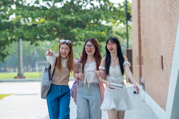 College students walking together outdoors, Group of happy friend students walking at the campus