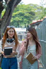 College students walking together outdoors, Group of happy friend students walking at the campus