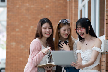 Group of young student using laptop smartphone to brain storm presentation, homework, discussing, planning to new project