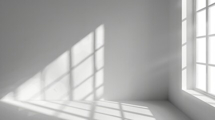 Fototapeta premium Minimalist empty interior of a white room with blurred natural light entering through windows. Shadow overlay, abstract background for product presentation.
