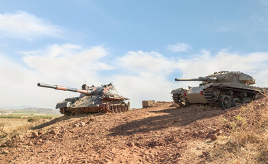 Fototapeta premium Syrian and Israeli tanks destroyed during the Yom Kippur War are in the Valley of Tears at the OZ 77 Tank Brigade Memorial on the Golan Heights in northern Israel