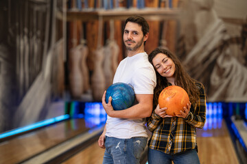 happy couple enjoying an afternoon together playing bowling