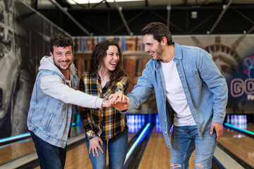 group of friends enjoying an afternoon together playing bowling