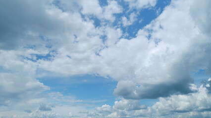 Light high clouds slide on sky. Layer of clouds in blue sky moving horizontal in opposite direction. Timelapse.