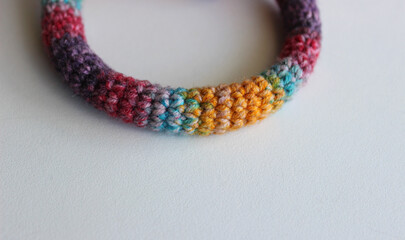 Fibers of variety colors natural wool are braided into a thick rope 
