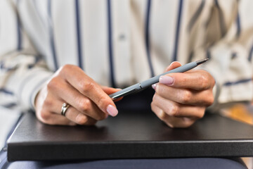 hands of African American therapist expert hold pen on notebook