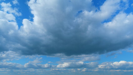 Fototapeta premium Sky and dark cloud. Beautiful sunny blue sky with rain clouds background. Time lapse.