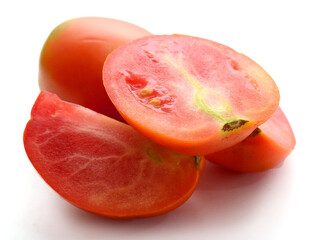 Fresh red ripe tomatoes against white background - stock photo
