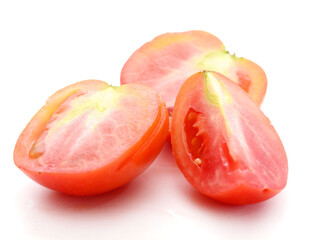 Fresh red ripe tomatoes against white background - stock photo
