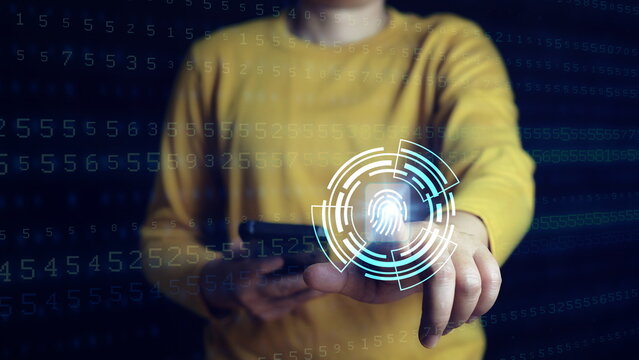 Businessman using thumb to scan finger print or for digital processing biometric identification to access security system includes internet banking, cloud system and mobile phone