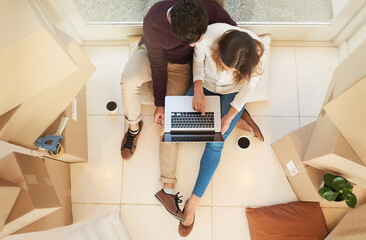 Boxes, coffee and couple on floor with laptop for mortgage research and ecommerce for furniture....
