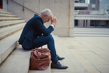 Mature, businessman and stress on steps in city for financial, career and headache from tax. Debt, corporate and accountant on stairs in New York for stock market, frustrated and anxiety for economy