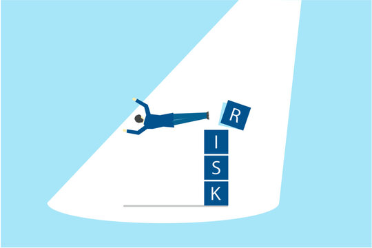 リスクの文字にドロップキックを放つビジネスマン