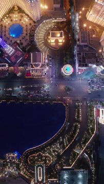 Vertical Screen: Stunning aerial vertical footage captures the lively Las Vegas Strip at night with bright lights, famous landmarks, and busy streets, showcasing the citys vibrant nightlife