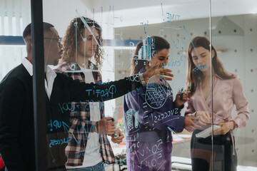 A multinational group of business professionals collaboratively brainstorming, using sticky notes on a glass wall filled with statistical data and creative ideas.