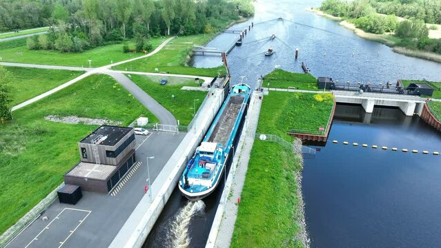 Aerial view on the new Reevesluis locks in the Drontermeer between Flevoland and Gelderland, Netherlands with a freight ship and other boats in the lock.