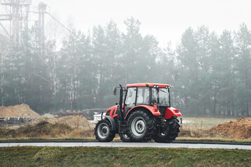 Tractor driving through fog on countryside road