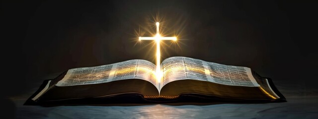 Opened Holy Bible on dark background with shining cross at centerfold. Christian banner with copy space
