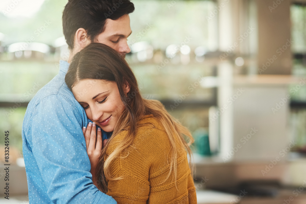 Wall mural smile, bonding and couple hugging in kitchen in morning for greeting, love and care at home. happy, 