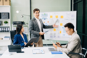 Office colleagues have a casual discussion. During a meeting in a conference room, a group of business teem