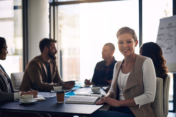 Business woman, portrait and boardroom with colleagues for corporate meeting, confidence or creative director. Employee, smile and conference room for project planning, brainstorming or teamwork
