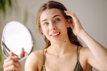 Portrait of a young woman without makeup with Acne skin. Concept of acne therapy, scars, inflammation on face and problem skin.