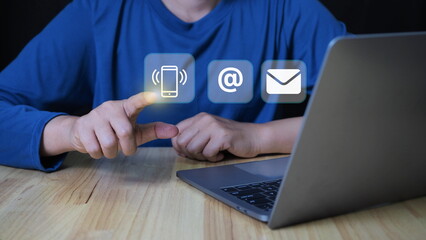 Person using laptop with contact us icon or Customer support hotline people connect.Contact us concept. Online customer service.