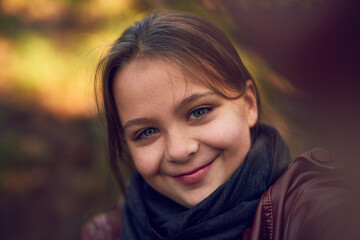 Outdoor, face and kid with smile, selfie and photography for memory in woods, winter and girl in...