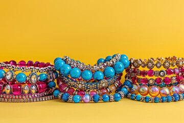 Jewlery collection for women,girls, teens, jewelery photography isolated on yellow backdrop.