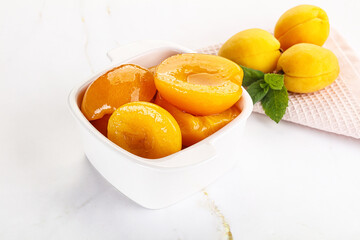 Few canned aprocots in the bowl