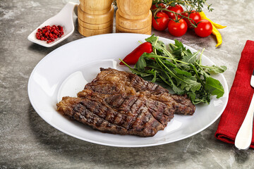 Grilled chuck roll steak with arugula