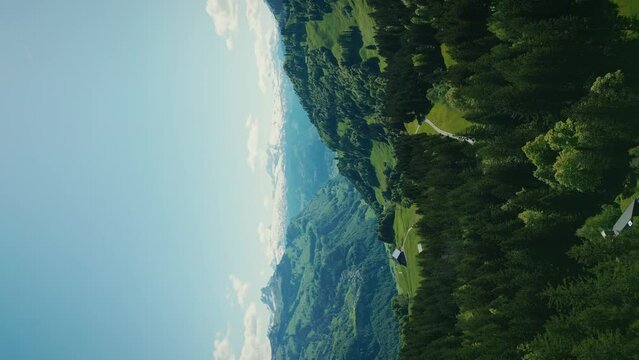 Snowy mountain peaks and green hills in Switzerland Alps, Stoos. Vertical video