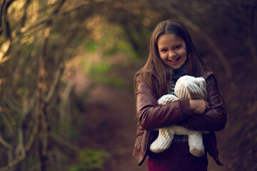 Happy, child and portrait with teddy bear in forest for nature exploration, adventure and journey....