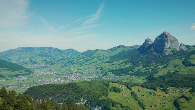 Aerial drone view of valley with village surrounded by Swiss Alps, Stoos