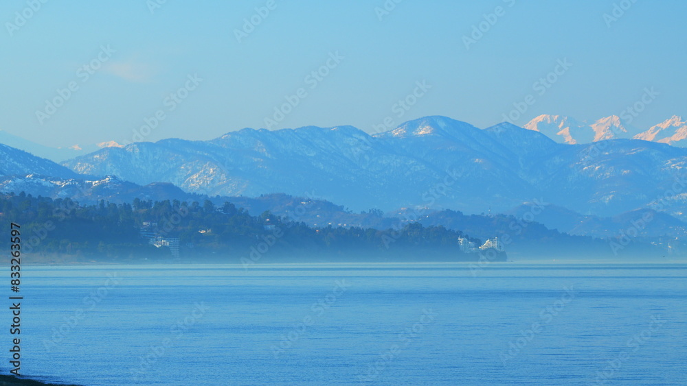 Wall mural Ocean Water Waves Movement. Snowcapped Mountain. Pan.