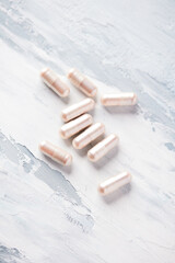 Carnitine capsules. Concept for a healthy dietary supplementation. Bright wooden background. Soft focus. Close up. Copy space.