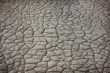 gray background with cracked old road. Texture of cracked asphalt close-up.