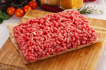 Raw minced beef meat over board