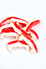 
Dracula or vampire teeth shaped gummy sweets isolated on white with copy space
