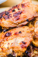 Grilled chicken thighs placed on a plate, captured in close up