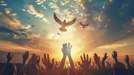 September 21 is the International Day of Peace. Silhouettes of a group of people stretching their hands up to a dove of peace floating in the sky at sunrise