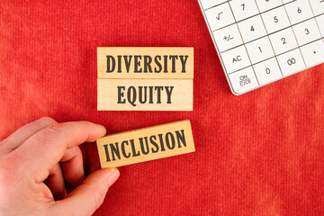 Words DEI, diversity, equity, inclusion appearing on a paper. DIVERSITY EQUITY INCLUSION on the...